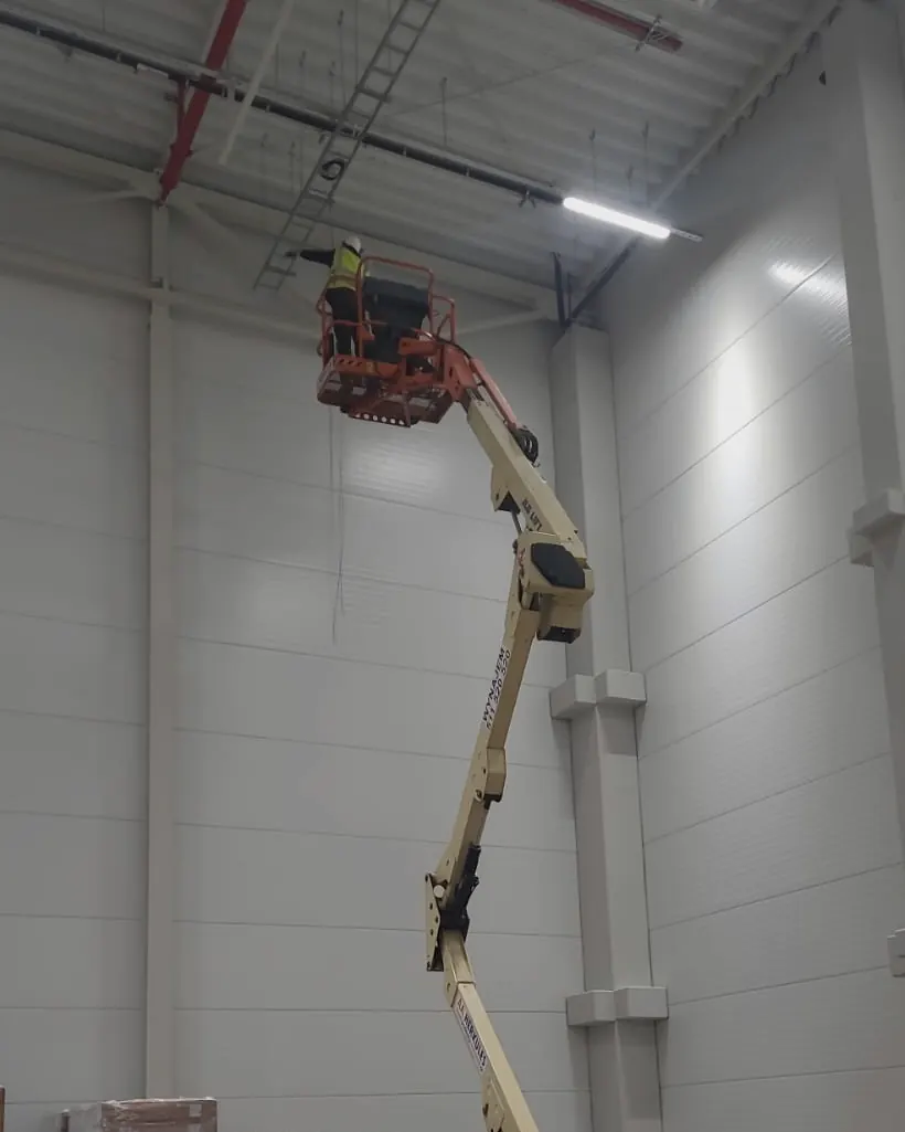Montaż instalacji monitoringu na hali z użyciem podnośnika
