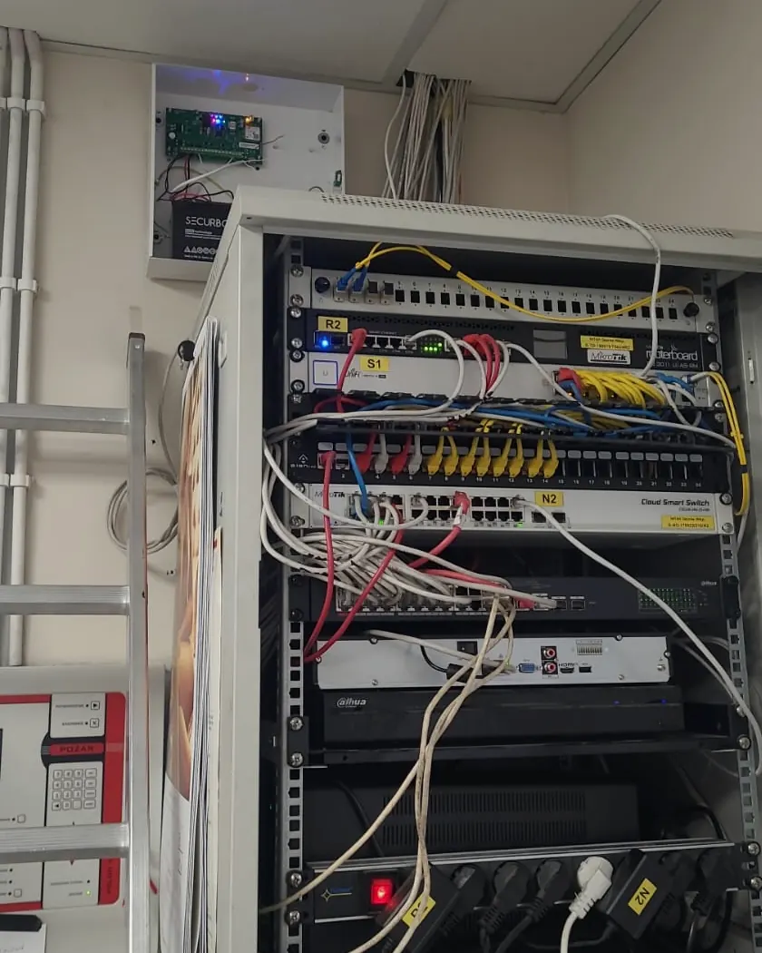 Realna szafa rack z rejestratorem, switchem PoE i okablowaniem monitoringu